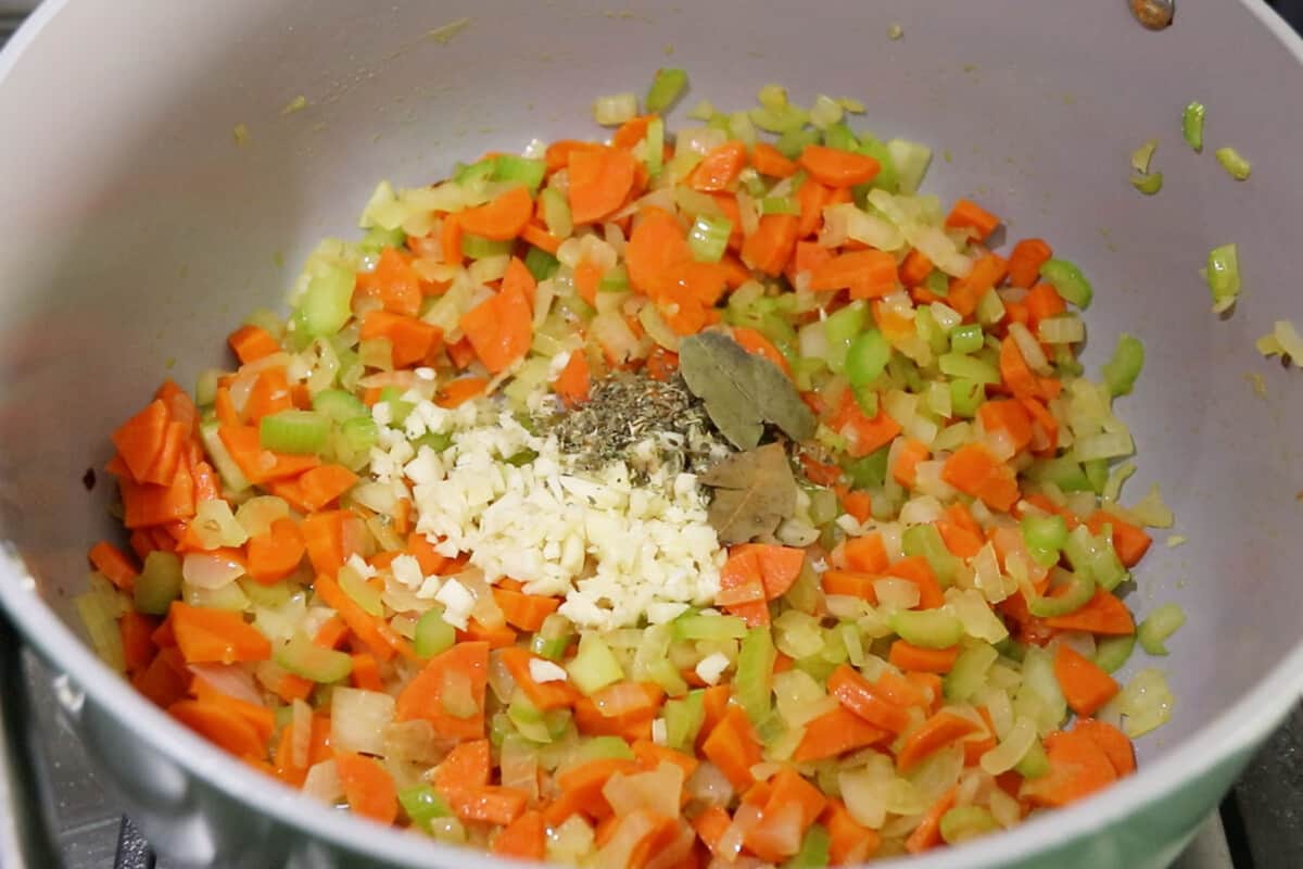 making Vegan Lemon Chicken Orzo Soup in large pot
