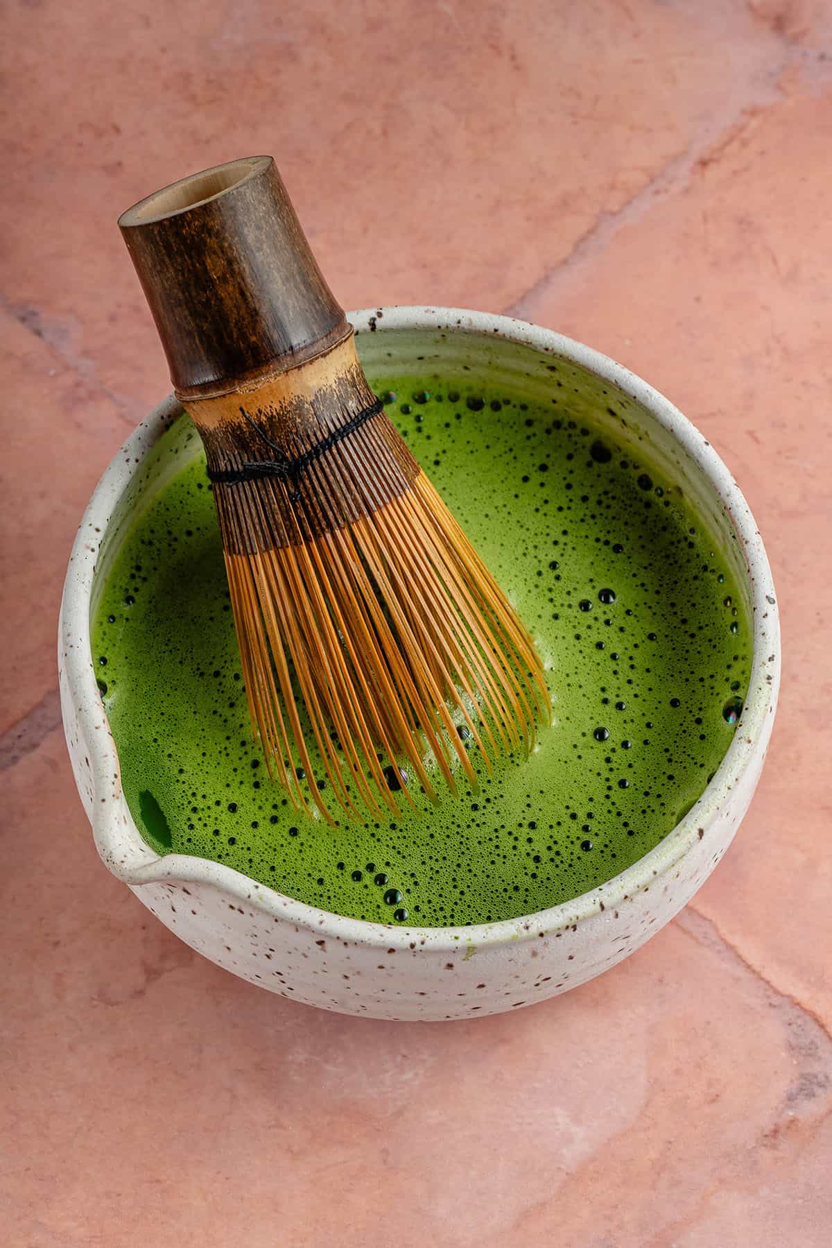 using chasen to whisk matcha and how water in white bowl