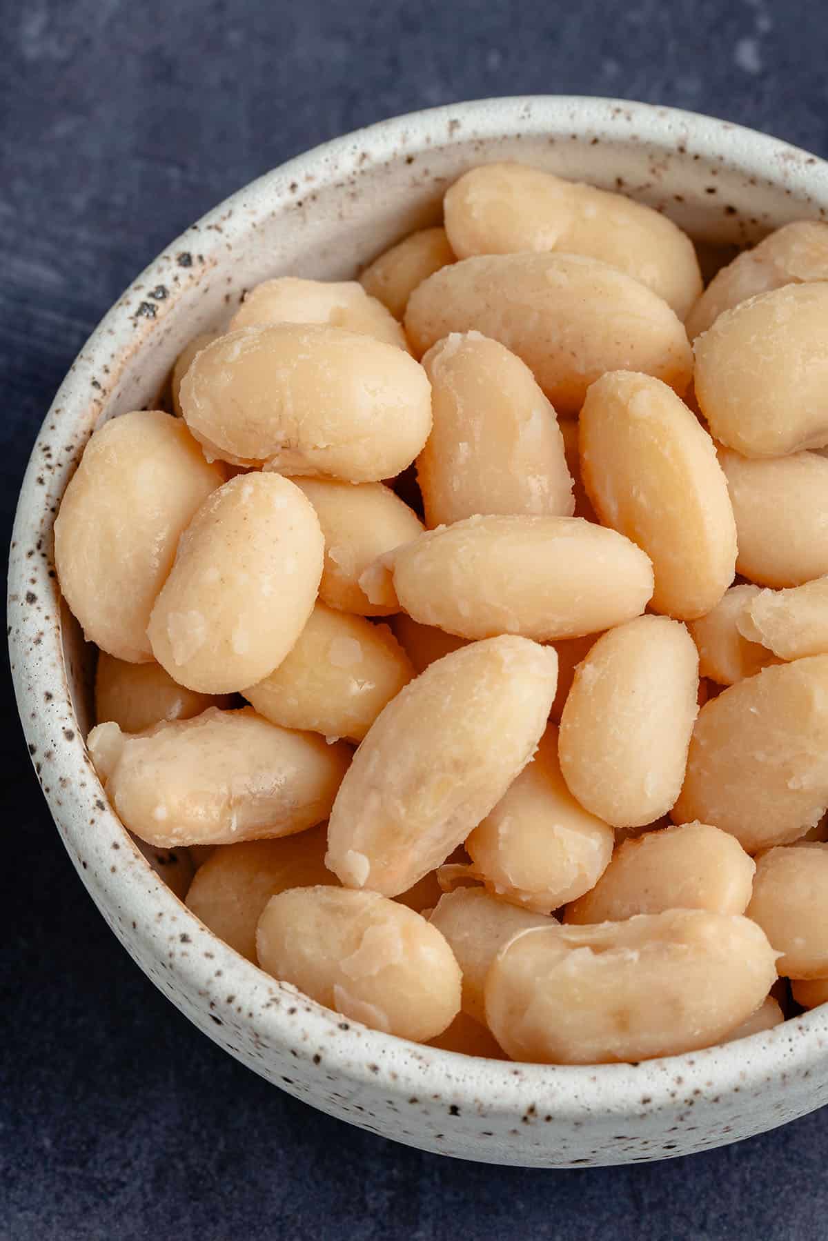close up photo of white beans in a white bowl