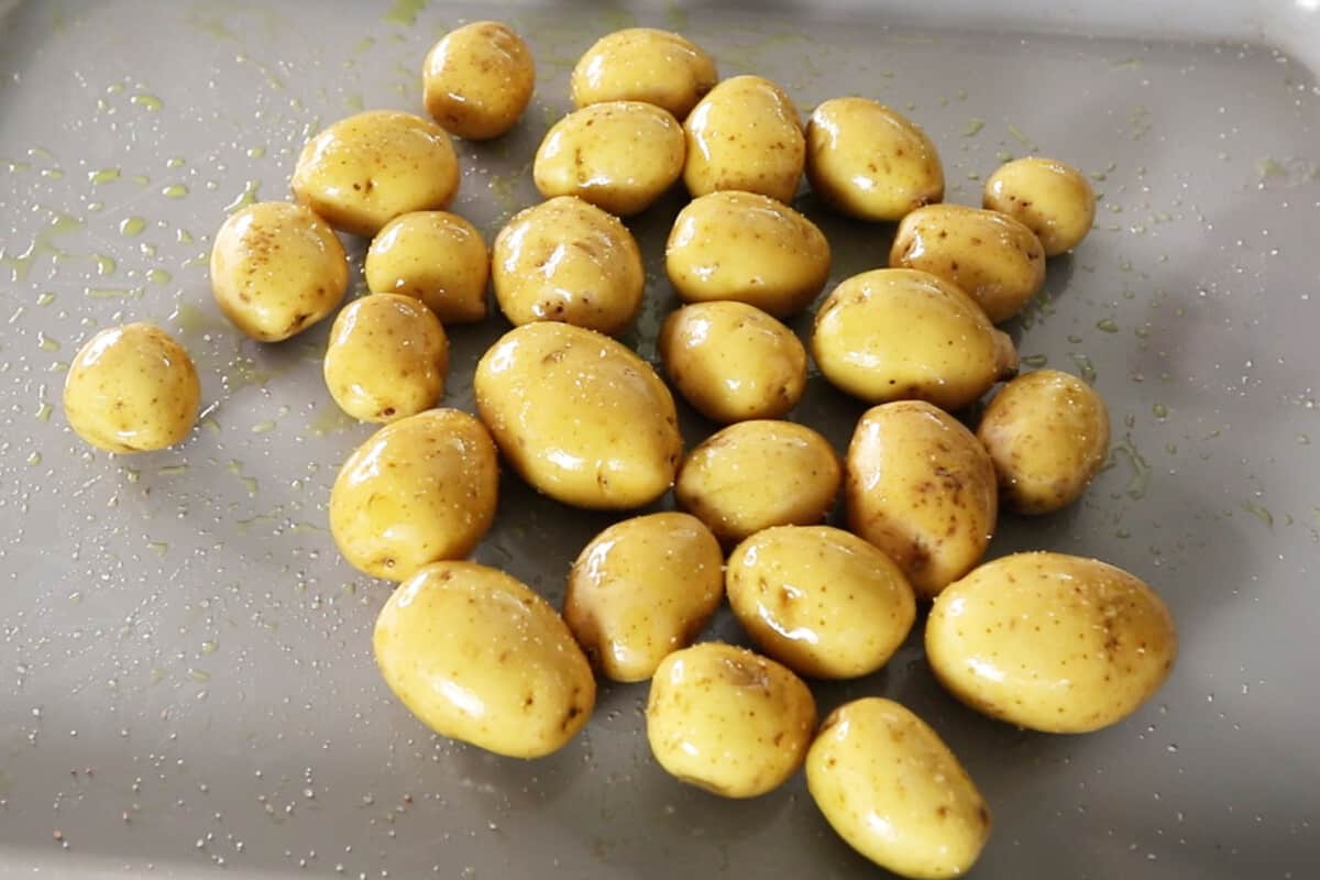 mini potatoes on baking sheet drizzled in oil