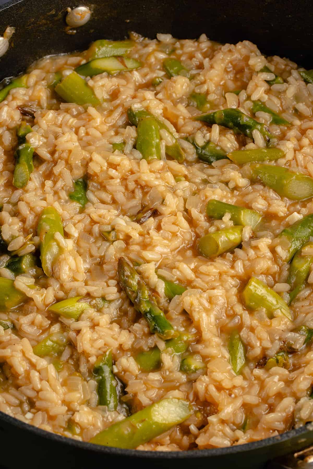 a pot of risotto with asparagus