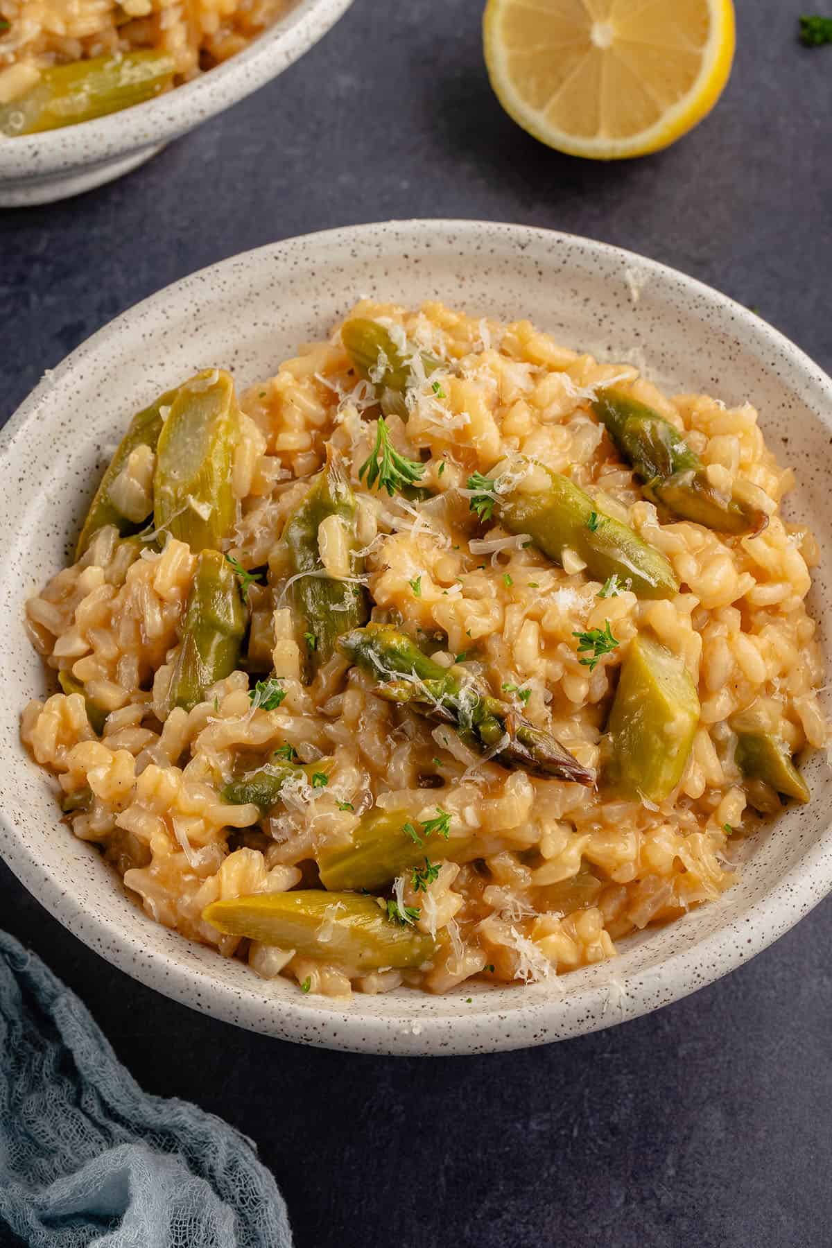 a white bowl of risotto topped parm