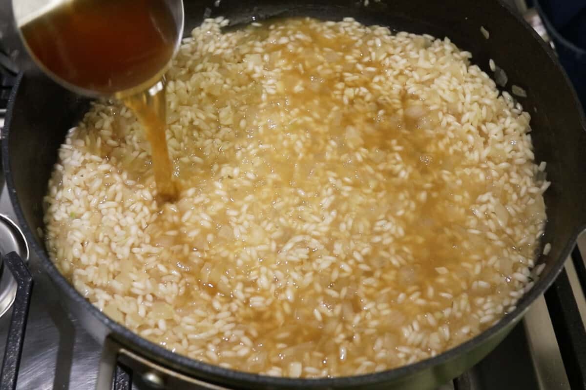 broth being added to risotto