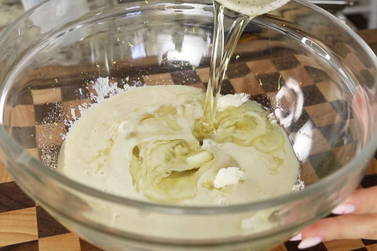 adding oil to large glass bowl for lemon loaf batter