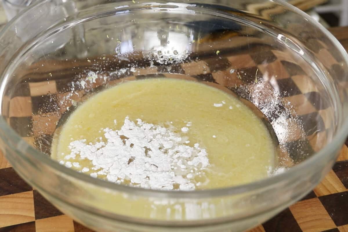 making batter for glazed vegan lemon loaf in large glass bowl