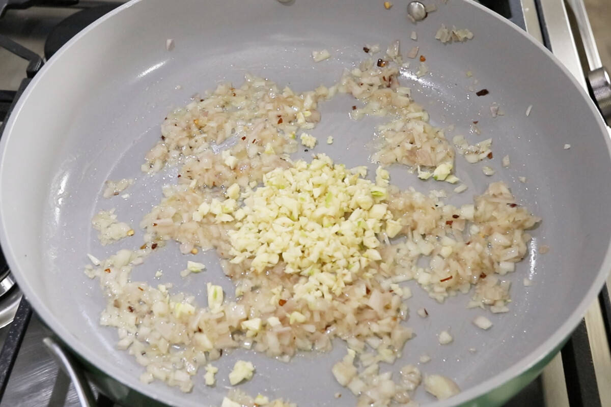 step by step: garlic being added to cooked shallots in a pan