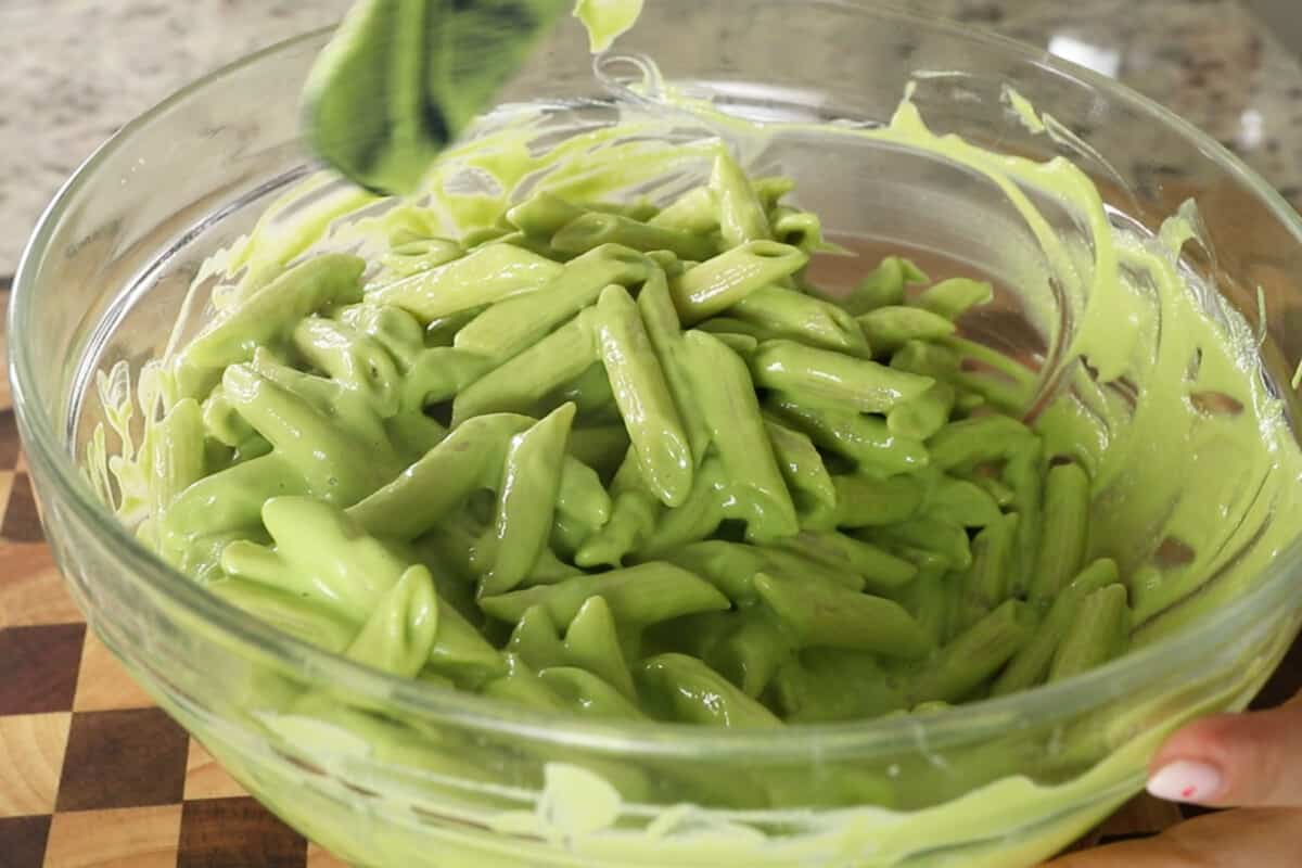 step by step: mixing cream pea pesto sauce into the pasta