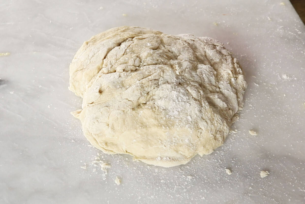 unbaked hawaiian roll dough before kneading on marble board