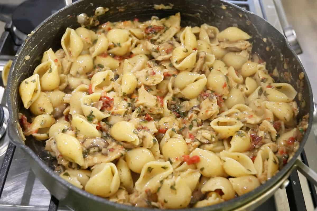 step by step : vegan tuscan chicken pasta cooked in a pan
