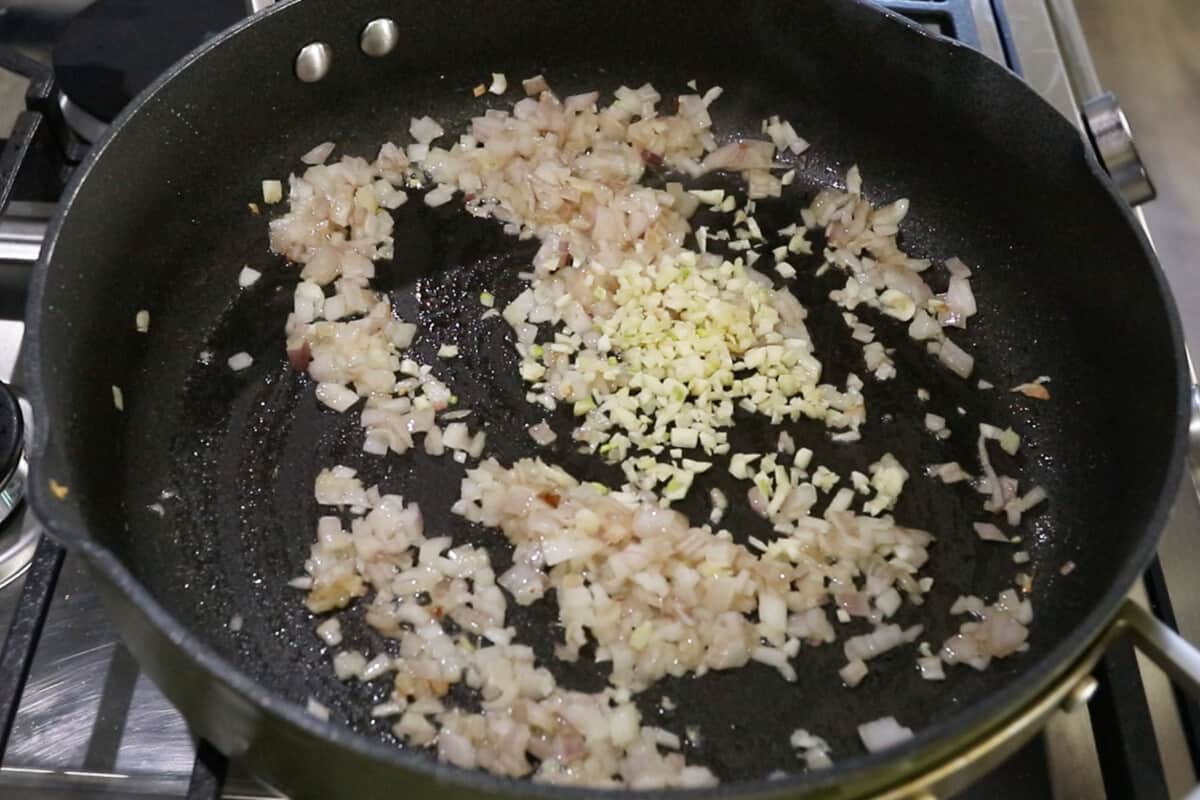 step by step - adding garlic to the pan