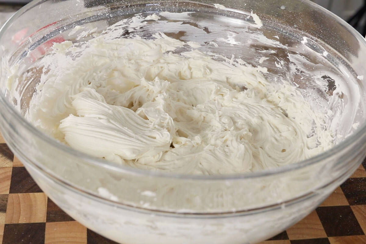 glass bowl of whipped buttercream frosting