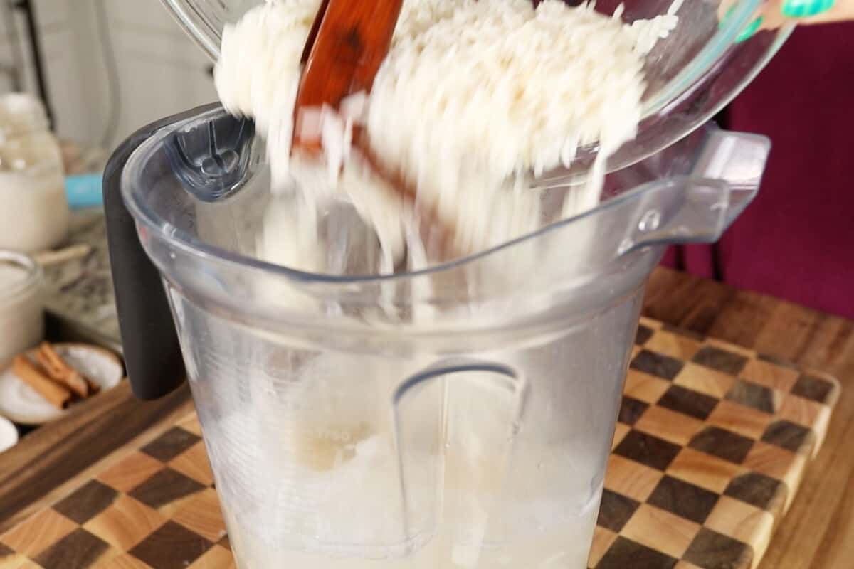 adding soaked rice and cinnamon sticks to blender for ube horchata