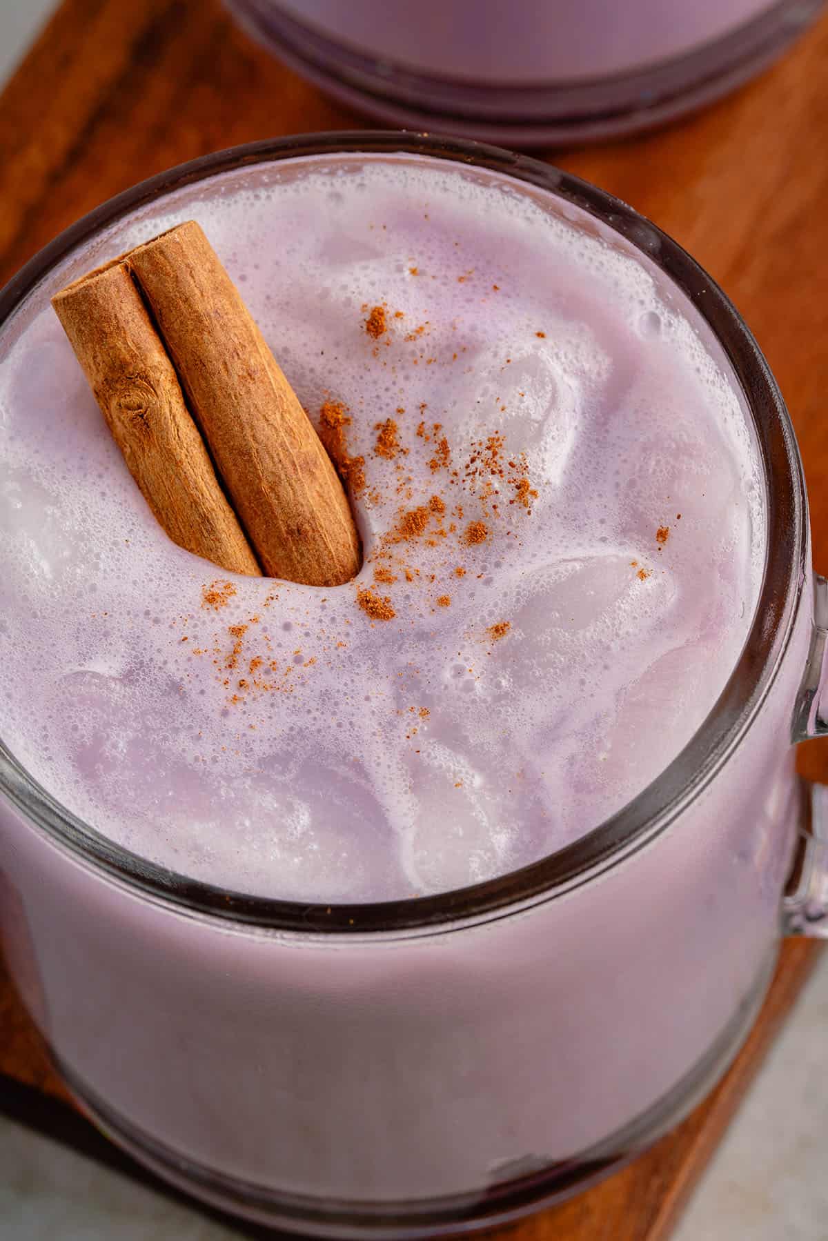 close up photo of ube horchata with ice and a sprinkle of fresh cinnamon