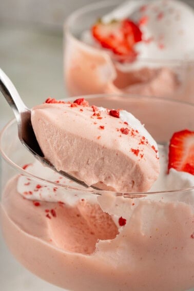 close up photo of spoon full of fluffy vegan strawberry mousse