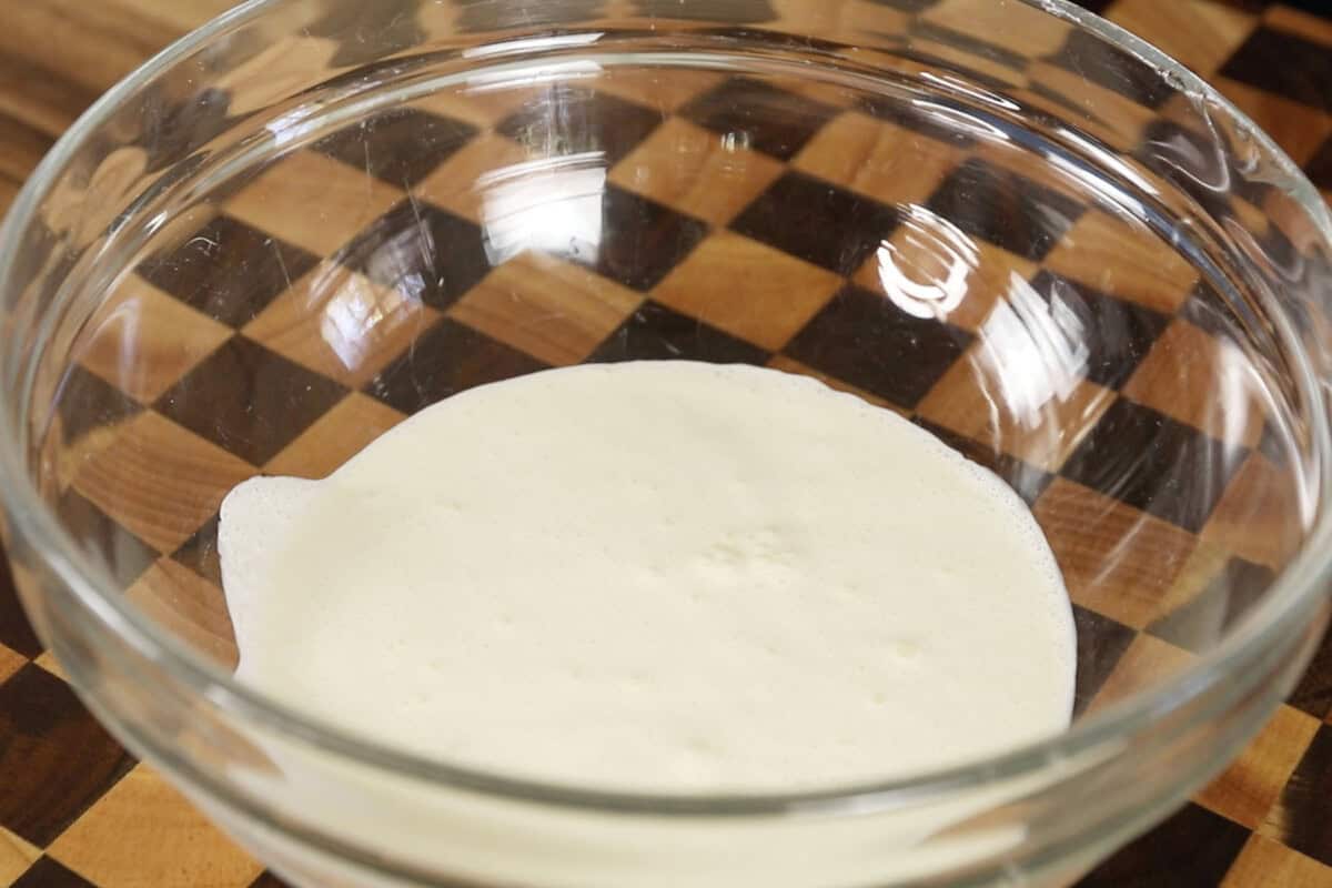 vegan whipping cream in large clear glass bowl