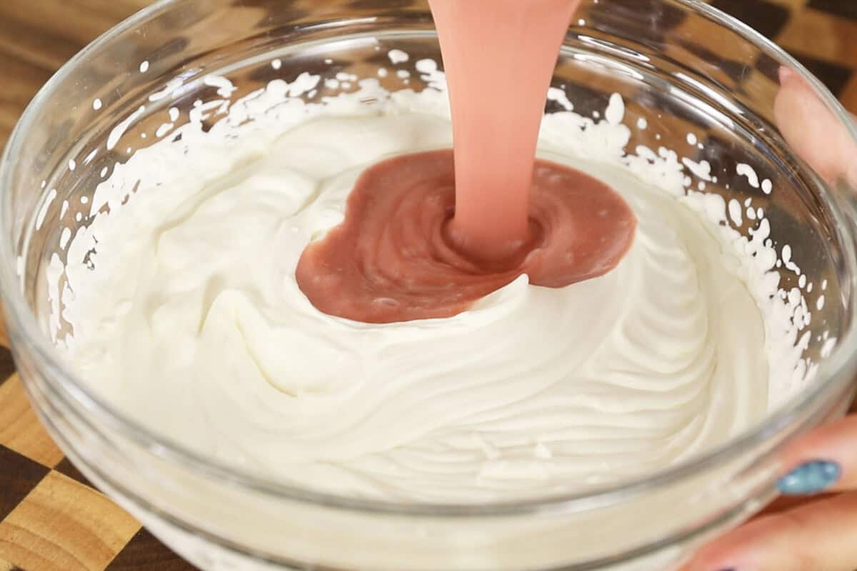 making strawberry mousse in large glass bowl