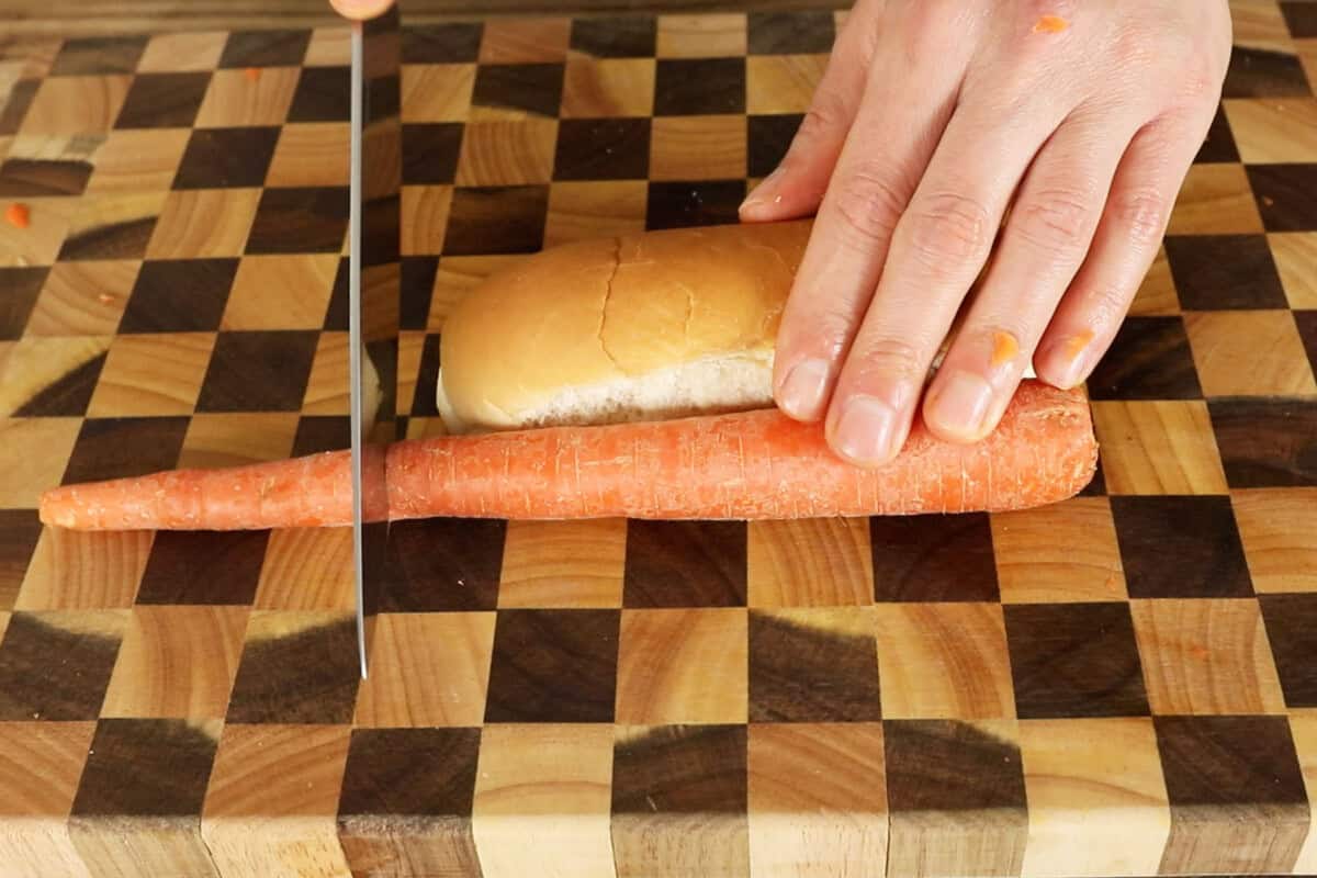 cutting carrot to be the same size as hot dog bun