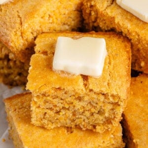 overhead image of cornbread squares with butter on top