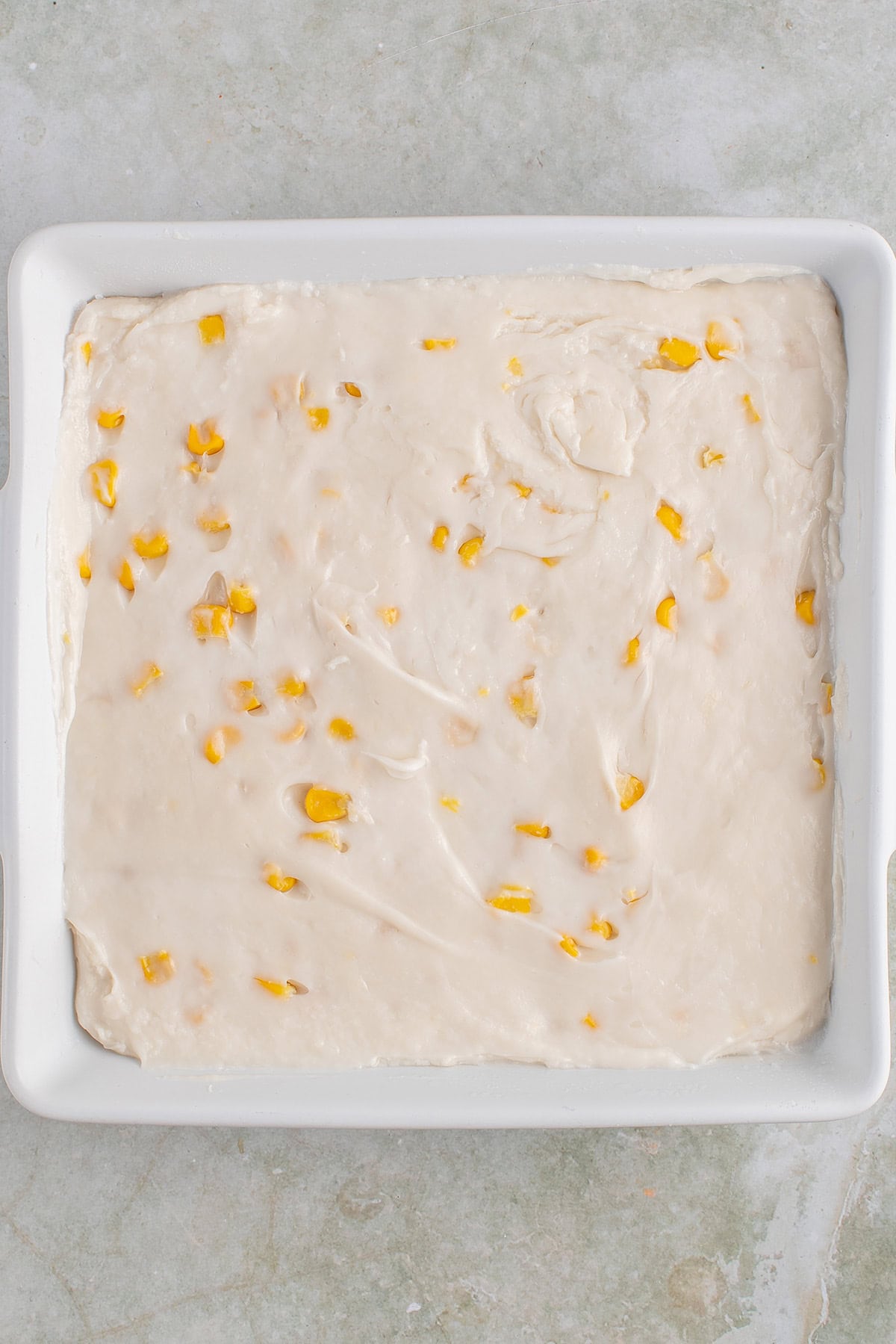 uncooked maja blanca in a white baking dish