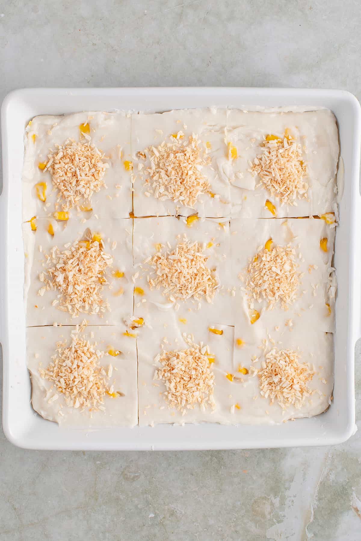 sliced maja blanca pieces in a square white baking dish