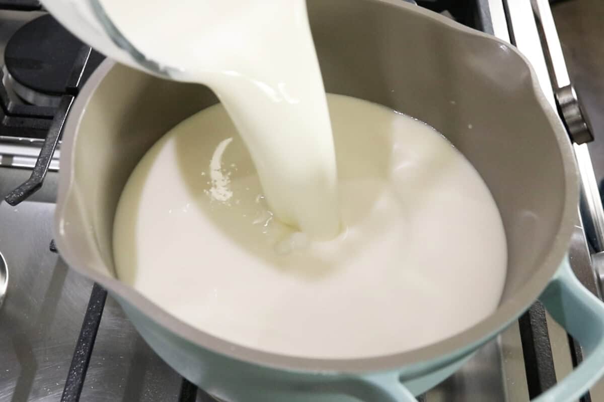 pouring evaporated milk into a pot