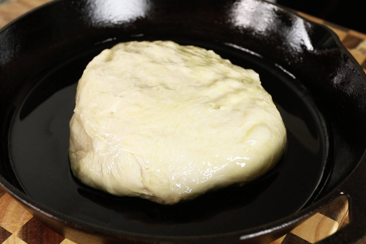 step by step - adding the dough ball into an oiled skillet