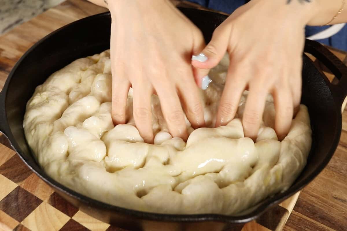 step by step - adding holes to the dough in the skillet