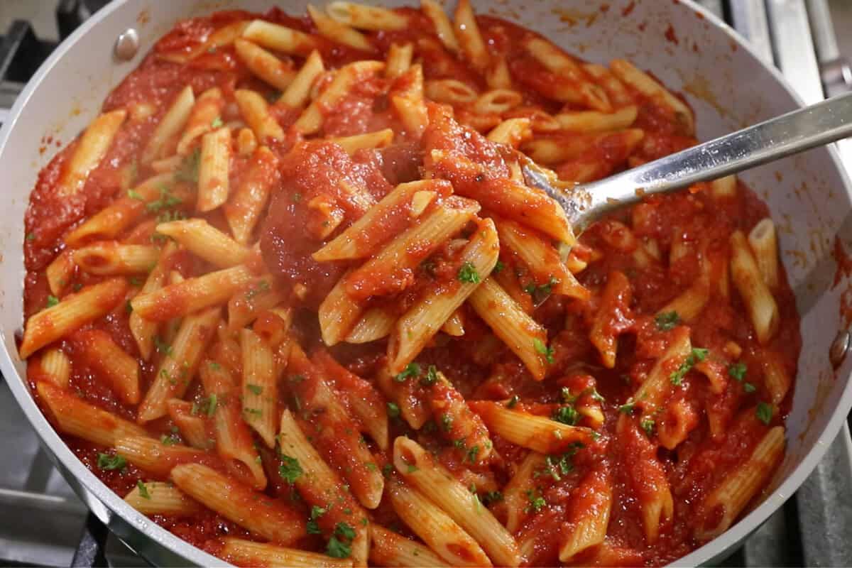 close up photo of Penne All'Arrabbiata (Spicy Tomato Pasta) in large skillet