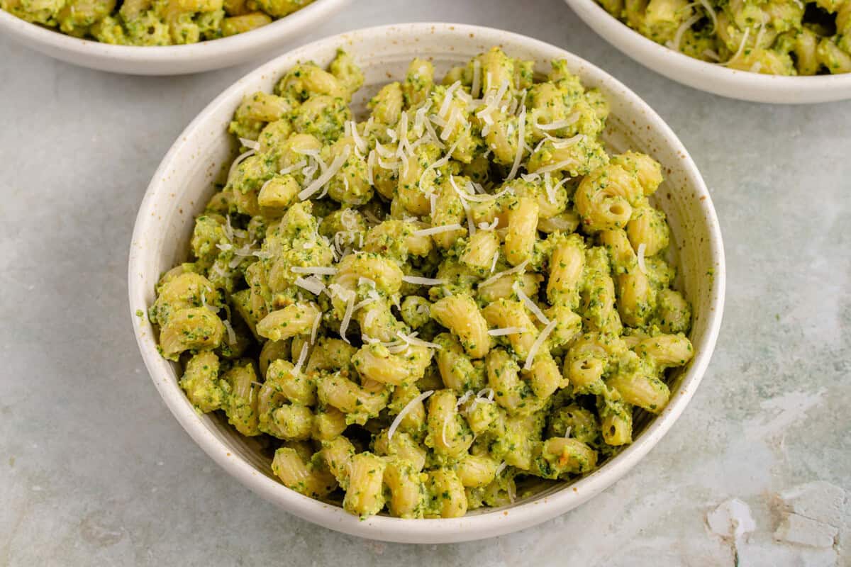 bowl of zucchini pesto pasta with dairy-free parm sprinkled on top