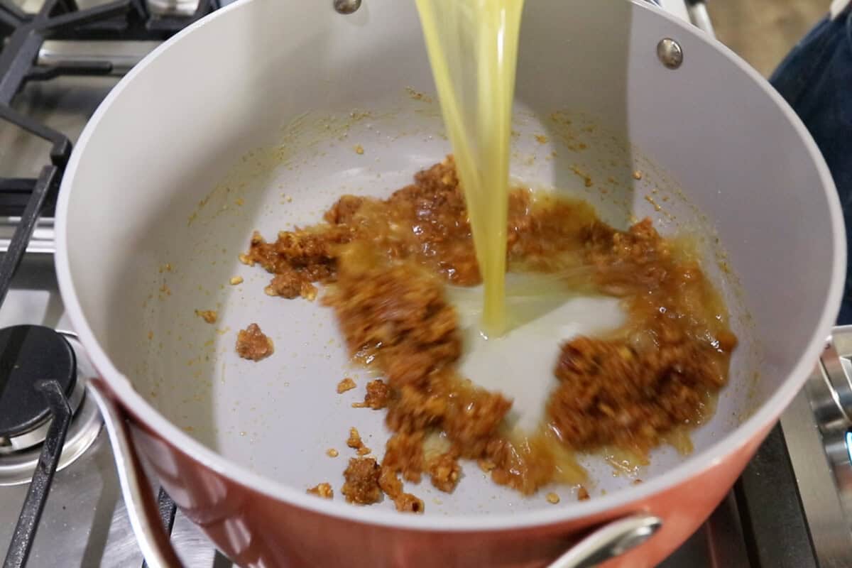 step by step: adding the broth into the pot