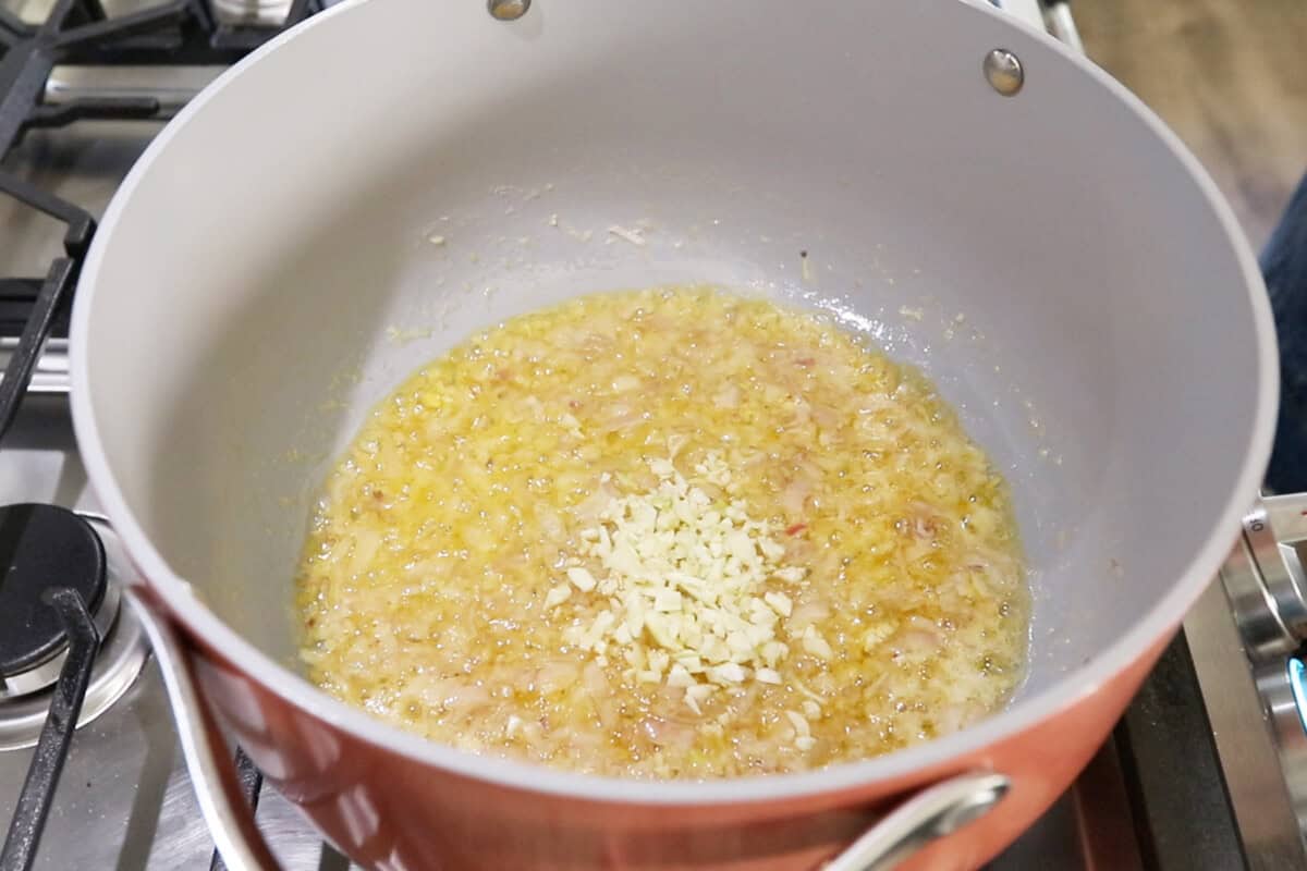 step by step: adding the garlic to the pot