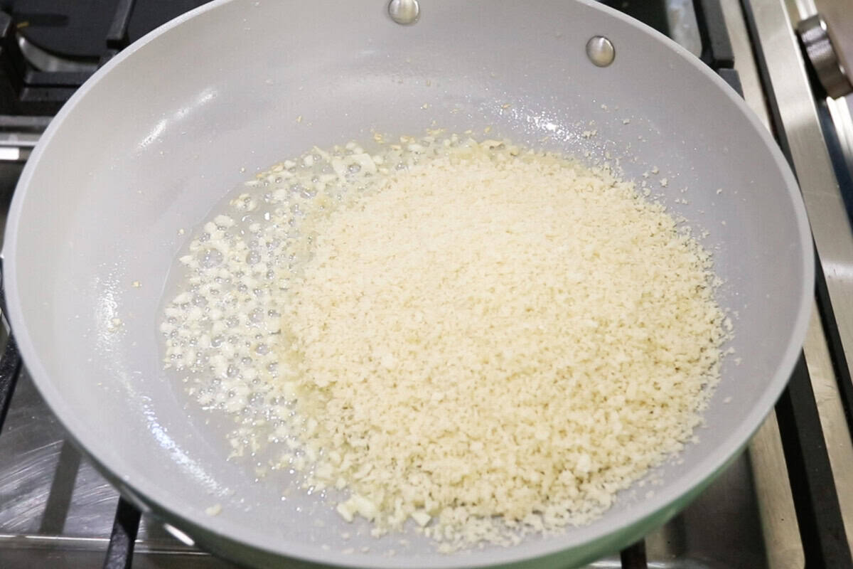 making garlic breafdrumbs in a nonstick caraway pan for Vegan Spinach Artichoke Pasta