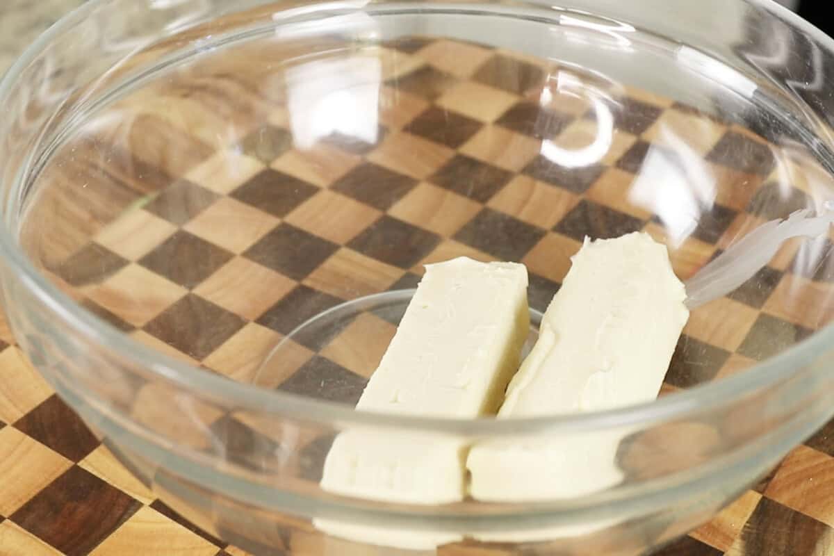 adding butter to a bowl