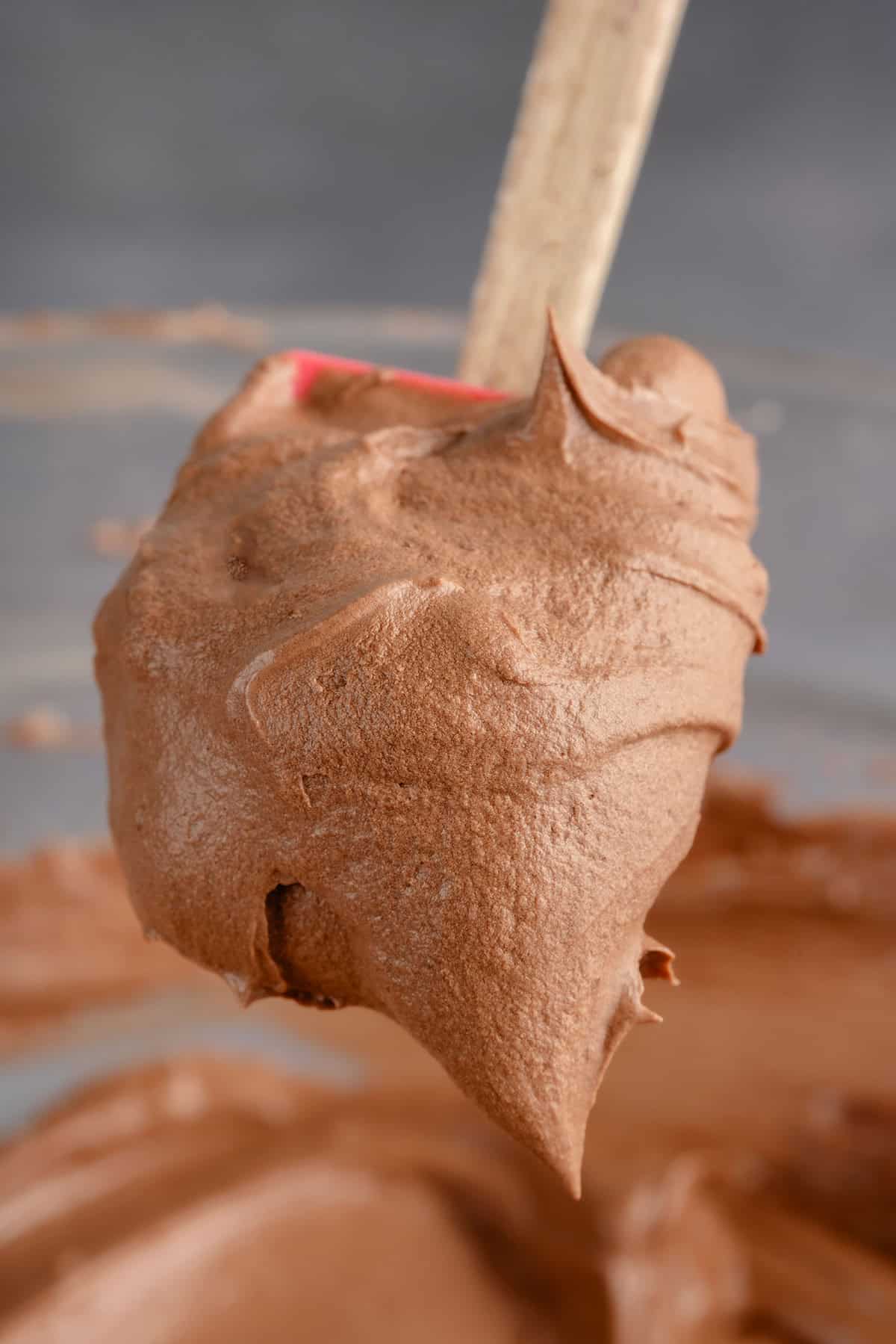 a scoop of chocolate buttercream on a spatula