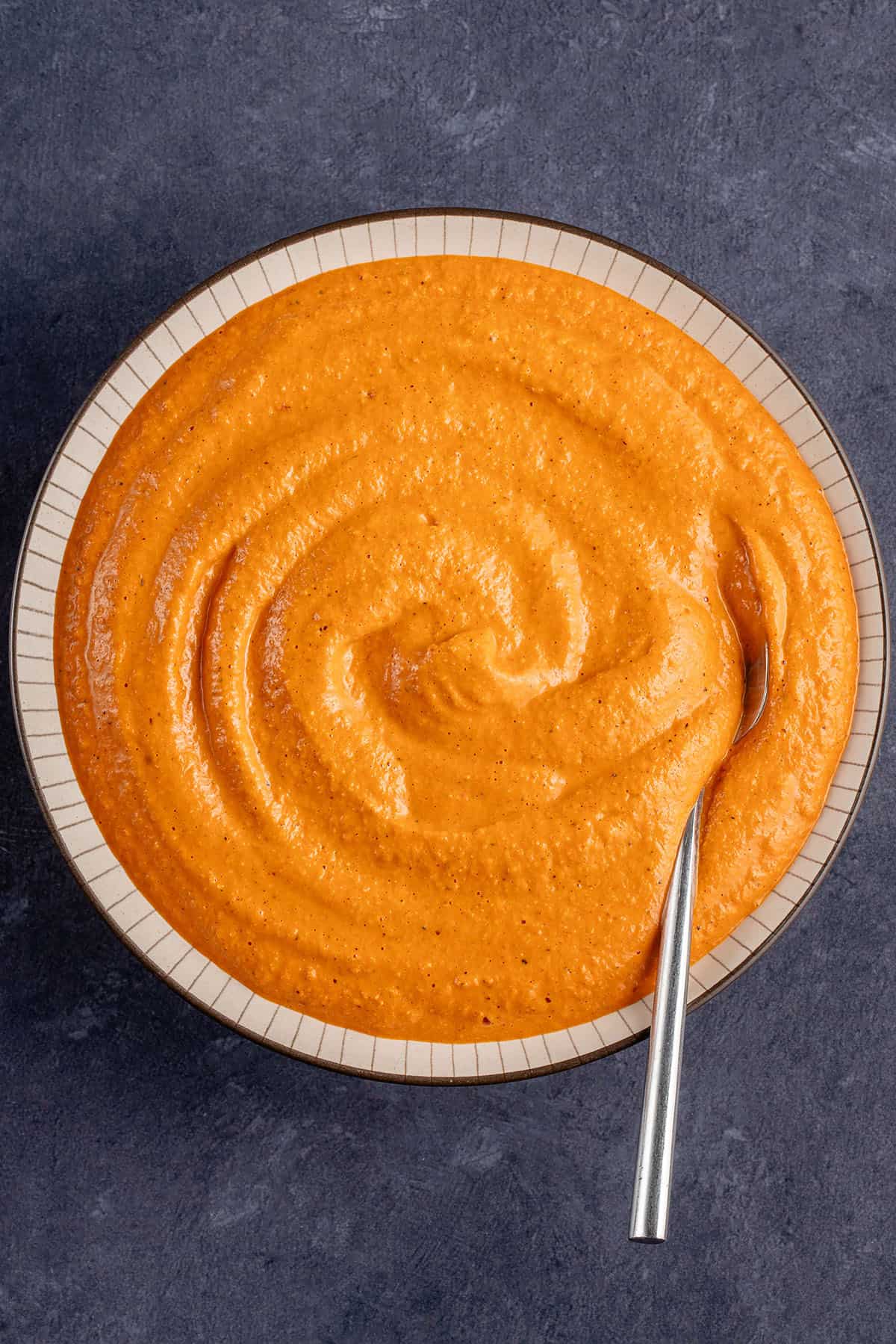 bowl of romesco sauce with a spoon