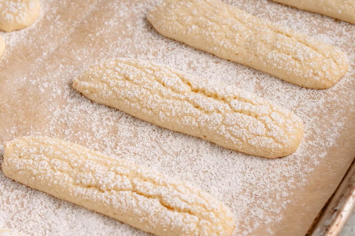 close up of homemade vegan ladyfingers on a baking sheet