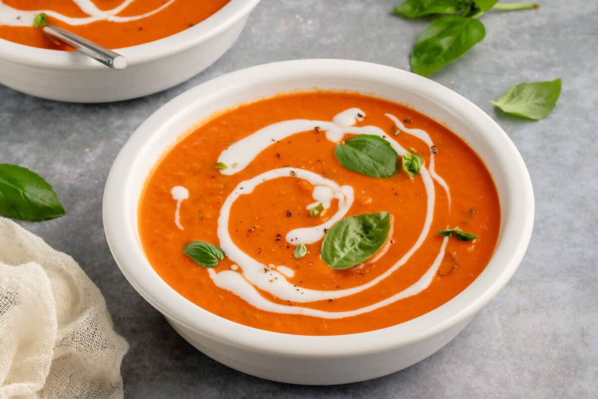 garnished bowl of soup with another bowl in the background