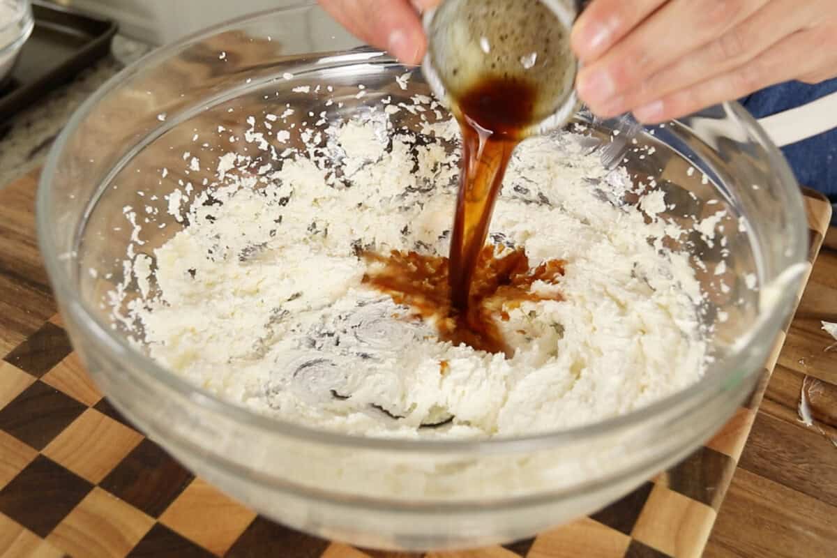 step by step: adding vanilla extract to creamed butter and sugar