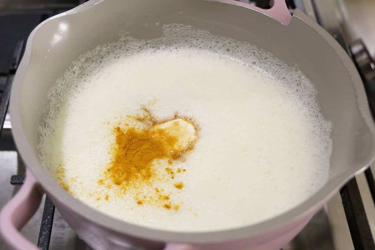 preparing vegan vanilla custard in a small pan