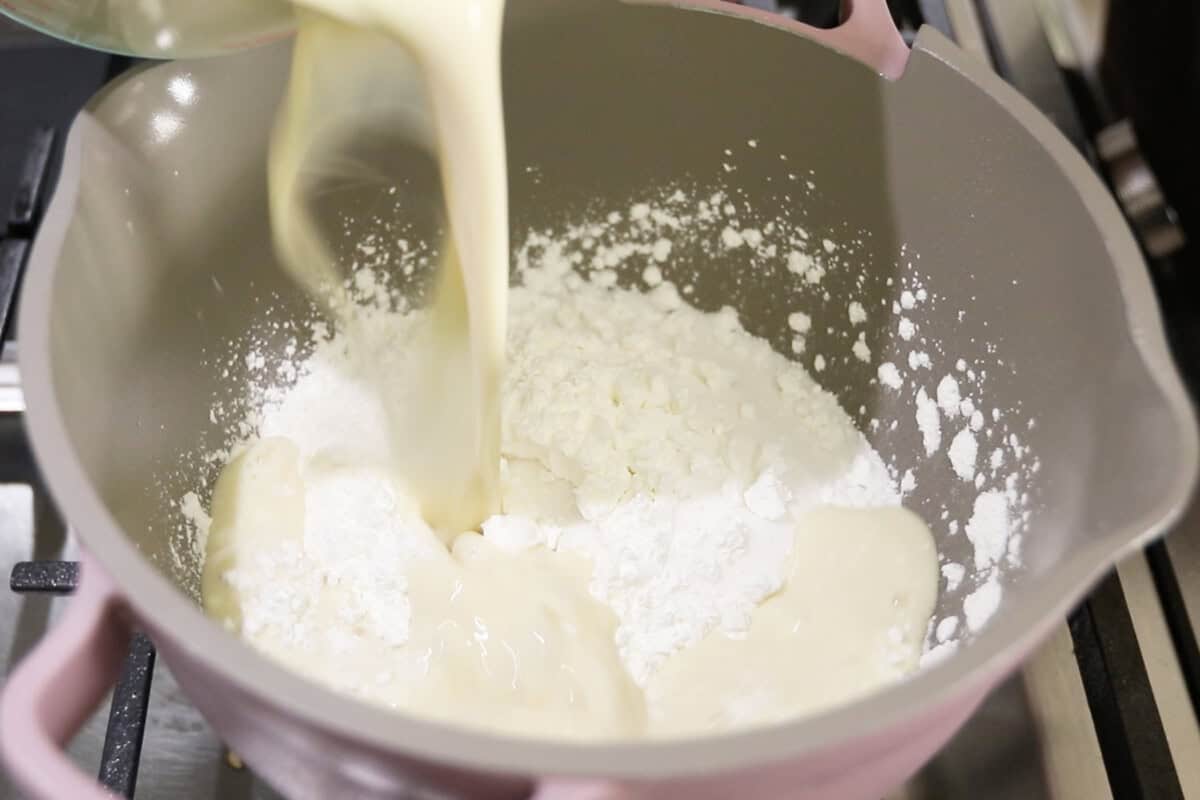 preparing vegan vanilla custard in a small pan