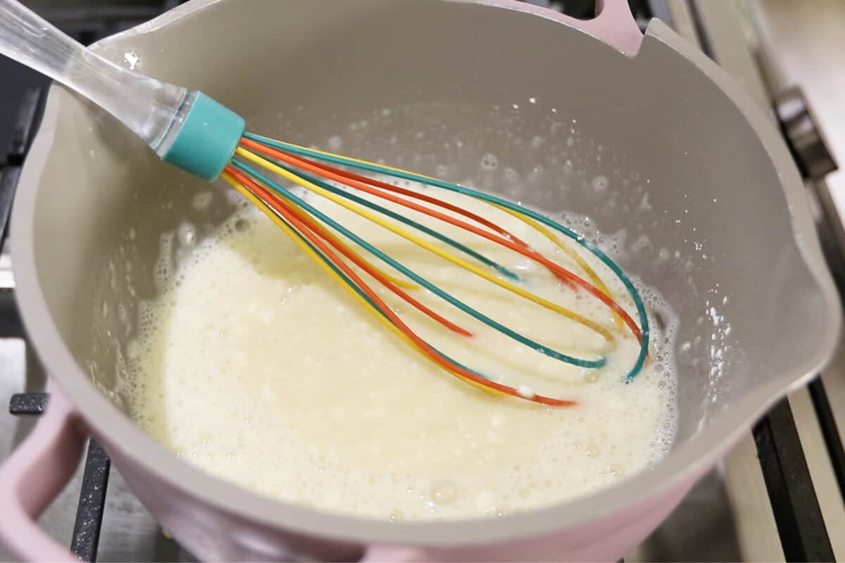 preparing vegan vanilla custard in a small pan