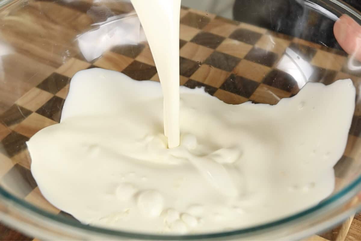 whipping vegan heavy cream in glass bowl