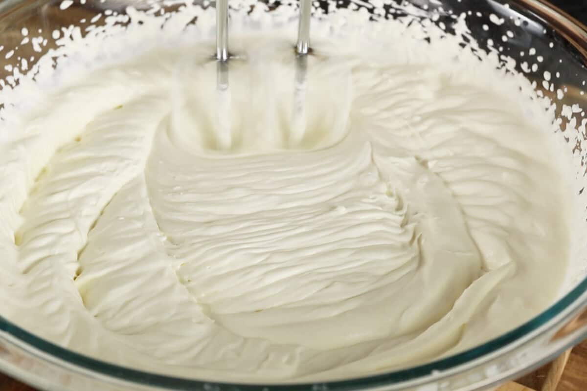 whipping vegan heavy cream in glass bowl