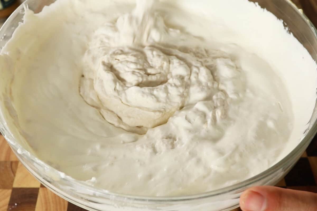 whipping cheesecake filling in a large bowl