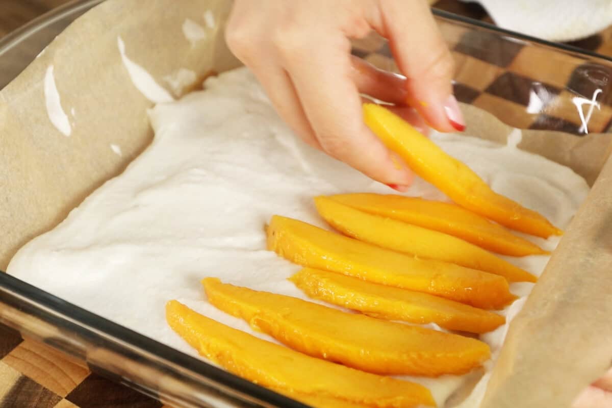 adding slices of mango