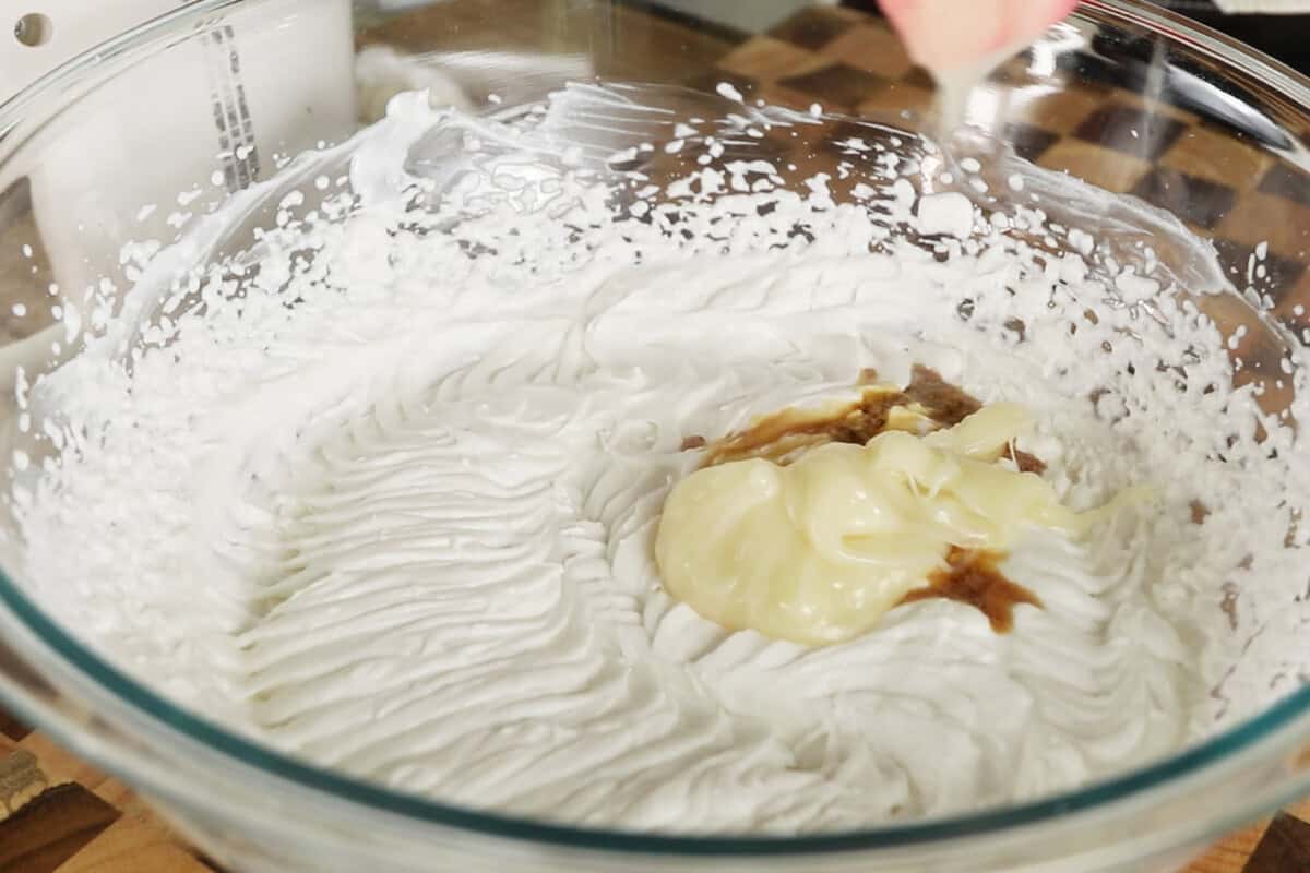 adding vegan evaporated milk to the bowl