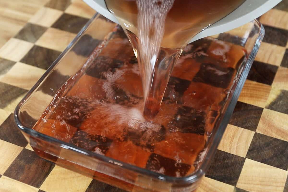 pouring liquid jello into container before setting