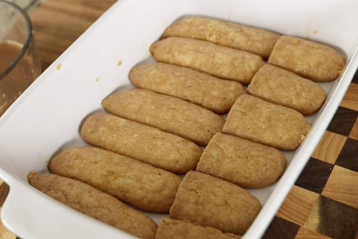 step by step: chai soaked ladyfingers lined in baking dish