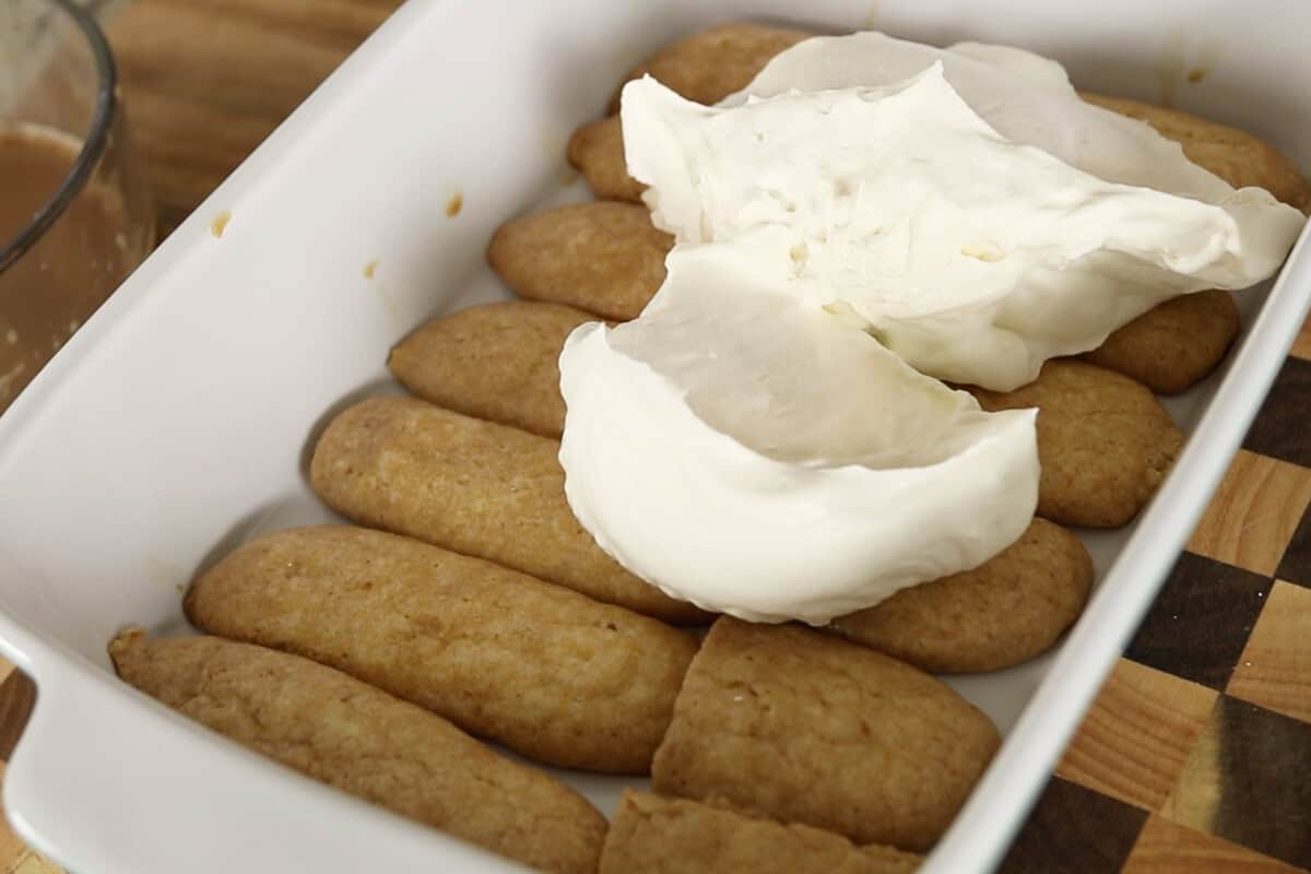 step by step: adding the cream over the ladyfingers