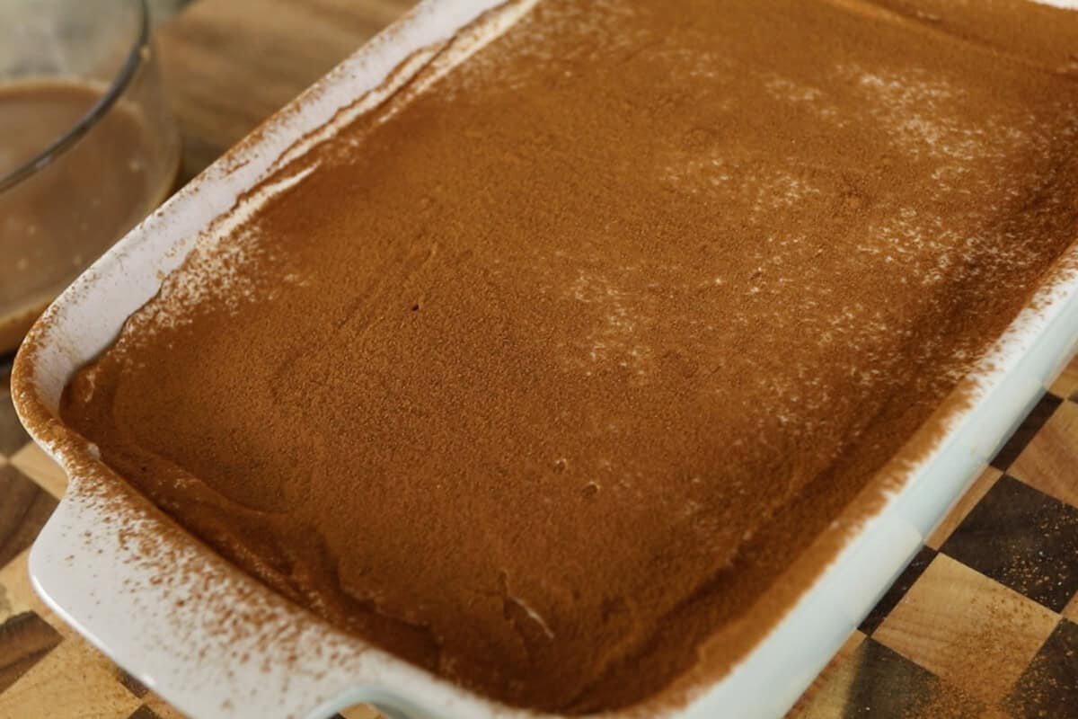 step by step: cinnamon dusted over the top layer of the tiramisu